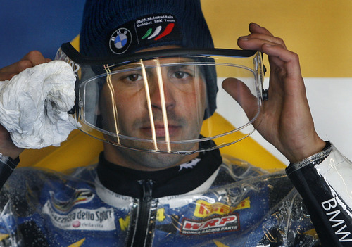 Scott Sommerdorf  |  The Salt Lake Tribune             
BMW rider Michel Fabrizio checks his visor as he cleaned it after coming in from an FIM Superbike World Championship free practice on the wet track at Miller Motorsports Park, Saturday, May 26, 2012.