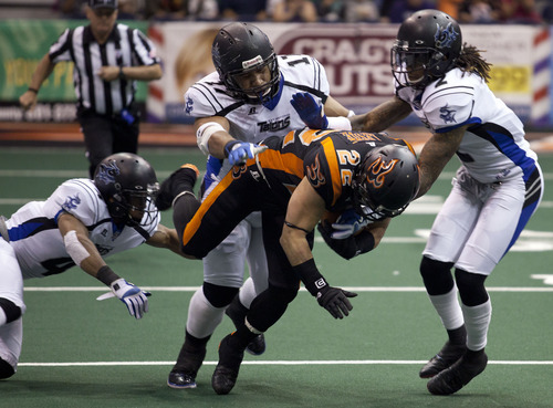 Lennie Mahler  |  The Salt Lake Tribune
Utah Blaze's Aaron Lesue is tripped up by Talon defenders as he runs for extra yards against the San Antonio Talons on Saturday, May 26, 2012, at EnergySolutions Arena.