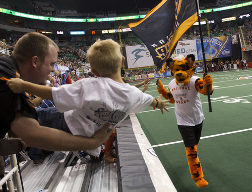 Lennie Mahler  |  The Salt Lake Tribune
Blaze fan Chris Burr holds his nephew, Tanner Kehr, out to get a high-five from Torch the tiger after the blaze scored a touchdown against the San Antonio Talons on Saturday, May 26, 2012, at EnergySolutions Arena.