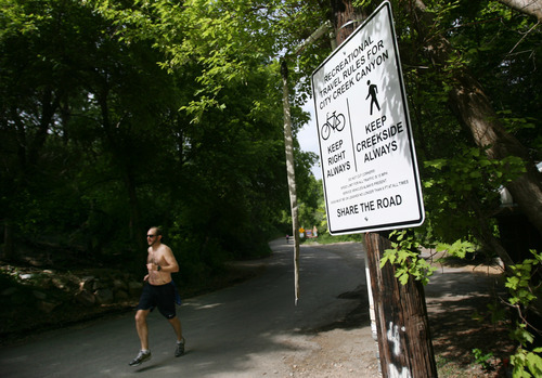 Kim Raff | The Salt Lake Tribune
A jogger runs past one of the new signs installed on the City Creek Trail for bikers and pedestrians in Salt Lake City, Utah on May 25, 2012.