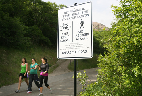 Kim Raff | The Salt Lake Tribune
People walk past one of the new signs installed on the City Creek Trail for bikers and pedestrians in Salt Lake City, Utah on May 25, 2012.