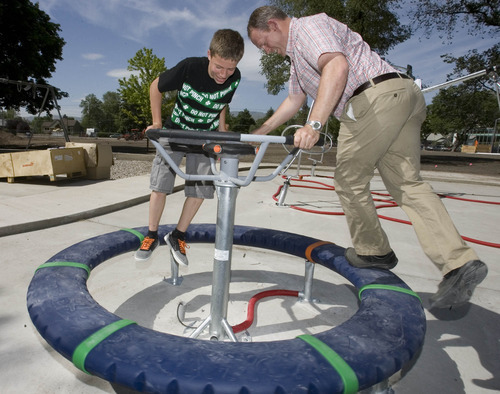 Paul Fraughton | Salt Lake Tribune
Soren Selph, 12, and his father Morgan Selph, a landscape architect for Salt Lake County Parks and Recreation, play recently on a high-tech apparatus at  Evergreen Park.