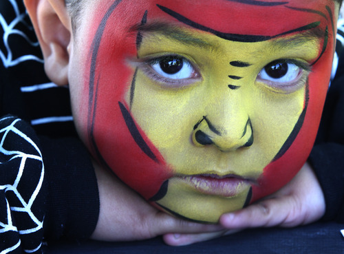 Rick Egan  | The Salt Lake Tribune 

Four-year-old Soni Vainuku, West Valley,  relaxes after having his face painted at the Valley View cemetery in West Valley, Monday, May 28, 2012. Valley VIew Cemetery offers free hot dogs and sodas to people visiting their family's graves, as well as face painting.