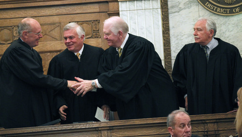 Al Hartmann  |  The Salt Lake Tribune 
Judge David Nuffer, left, is welcomed to the court by standing circuit court judges for the District of Utah after his swearing in Tuesday, May 29, in Salt Lake City.