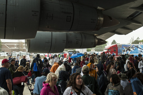 Chris Detrick  |  The Salt Lake Tribune
Spectators gather under the wing of an United States Air Force C-5 to get out of the rain during the Warriors Over the Wasatch airshow at Hill Air Force Base Saturday May 26, 2012.