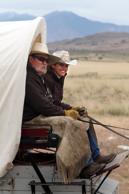 Rick Egan  | The Salt Lake Tribune 

Paul Bliss (left) and Miss Rodeo Utah, Jamie Udell, drive a wagon along a trail on Antelope Island during the 7th annual Cowboy Legends, Cowboy Poetry & Music Festival on Sunday, May 27, 2012.  The festival features wagon train rides, food, music, poetry and gun shows. It continues on Monday.