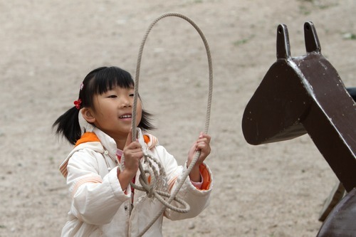 Rick Egan  | The Salt Lake Tribune 
Six-year-old Cindy Yang, from Nanjing, China, ropes a stationary horse at the Fielding Garr Ranch on Antelope Island during the 7th annual Cowboy Legends, Cowboy Poetry & Music Festival on Sunday.