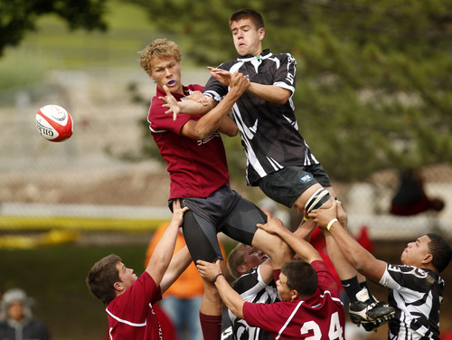 Trent Nelson  |  The Salt Lake Tribune
Herriman's Gabe Ruflin, left, and Trybe's Alex Alba reach for the ball as Herriman defeated Trybe for the Division 1 state rugby championship Saturday, May 26, 2012 at the University of Utah in Salt Lake City, Utah.