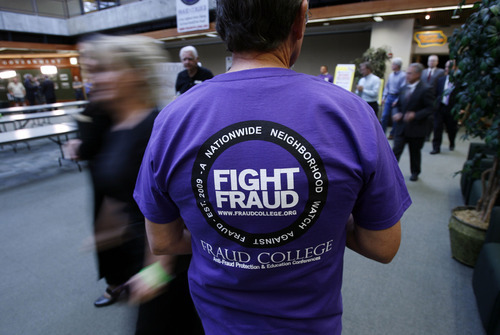 Francisco Kjolseth  |  Tribune file photo
Rex Ashdown, a former FBI agent and member of the FBI Citizens' Academy, helped out with Fraud College in 2010. A second Fraud College was held in February.