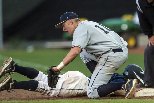 Chris Detrick  |  The Salt Lake Tribune
Timpanogos' Jordan Evans (5) dives safely back to first base past Skyline's Mike Staes (10) during the 4A championship game at Kearns High School Friday May 25, 2012.