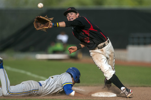 Chris Detrick  |  The Salt Lake Tribune
American Fork's Jake Miles (23) can't make a catch as Taylorsville's Mark Lesuma (17) dives safely back to first base during the 5A championship game at Kearns High School Friday May 25, 2012.  American Fork won the game 5-4.