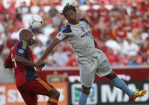 Steve Griffin | The Salt Lake Tribune
Real Salt Lake's Jamison Olave, left, heads the ball away from  Minnesota's Amani Walker during first-half action at Rio TInto Stadium in Sandy on May 29, 2012.