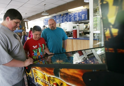 Kim Raff | The Salt Lake Tribune
Dawson, left, Ean and Jake Brown play at a pinball machine at the Dairy Delight in Tooele.
