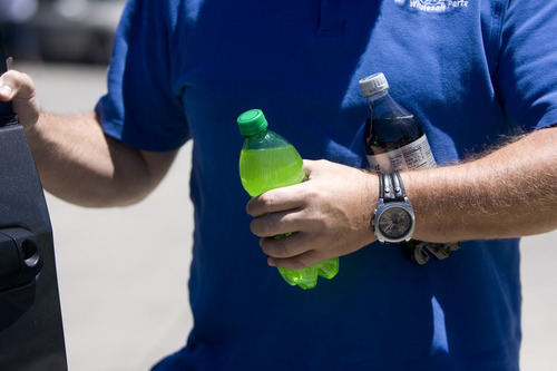 Kim Raff | The Salt Lake Tribune
Casey Cochrane holds soda's he has purchased as he gives his opinion about New York's plan to ban large sugary drinks outside of a Maverick gas station in Salt Lake City, Utah on May 31, 2012.