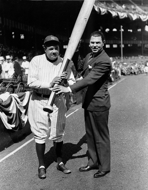 Boxing great Jack Dempsey presents New York Yankees slugger Babe Ruth with a king-sized bat before a game between the Yankees and Red Sox at New York's Yankee Stadium, April 13, 1933. (AP Photo)