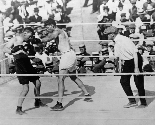 Challenger Tommy Gibbons, left, pulled back as heavyweight champion Jack Dempsey missed with a left during their title bout in Shelby, Montana, on July 4, 1923. The referee was Jim Dougherty, who then lived near Philadelphia, Pennsylvania. Gibbons, 69, died in his sleep at his St. Paul, Minnesota, November 19. (AP Photo)