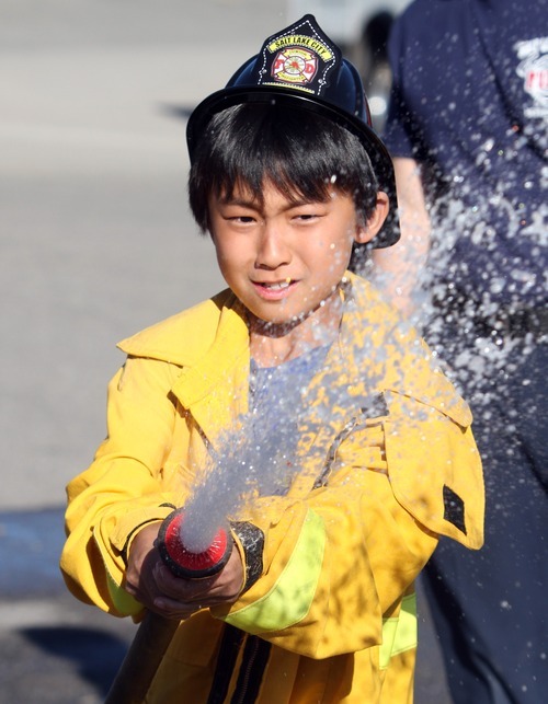 Rick Egan  | The Salt Lake Tribune 

Yuxang Fan, 10, sprays water during the Firefighter Combat Challenge for the kids at the safety fair at Fire Station #7, near the Utah State Fairgrounds, Friday, June 1, 2012.