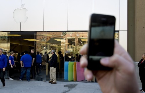 Djamila Grossman  |  The Salt Lake Tribune

A person takes a photo of the the Gateway Apple store, shortly after the new iPads 2 were released for sale on March 11, 2011. The popular electronics retailer is breaking its lease to move to City Creek.