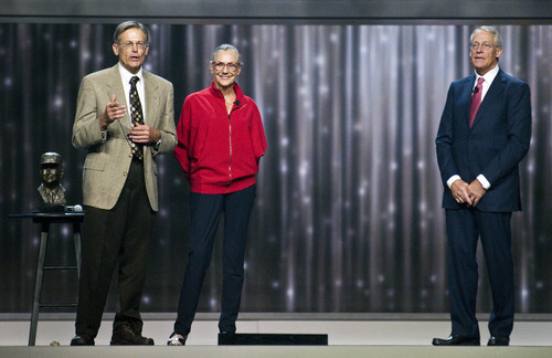 Children of the Wal-mart Stores Inc. founder the late Sam Walton, from left, Jim Walton, Alice Walton, and Robson Walton, right, chairman of the board of Wal-mart, announce the entrepreneur of the year award during the company's annual shareholders' meeting in Fayetteville, Ark., Friday, June 1, 2012. (AP Photo/April L. Brown)