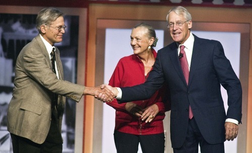 Jim Walton, left,, Alice Walton, center, and Robson Walton, right, greet each other during the beginning of the Walmart Stores Inc. shareholders' meeting in Fayetteville, Ark., Friday, June 1, 2012. The three siblings are the children of the late Sam Walton, founder of Walmart. (AP Photo/April L. Brown)
