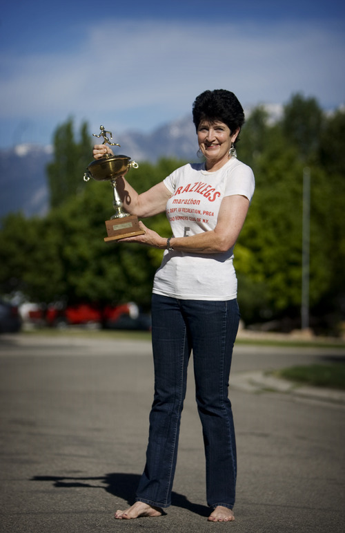 Kim Raff | The Salt Lake Tribune
Jacki Dixon, of West Jordan, was the first woman to win the first woman's long-distance race in 1972, known as the Mini. She was 17 at the time. This is the 40th anniversary of the Mini, which is a 10k race for women through NYC's Central Park. She is photographed with the trophy she won and the shirt she competed in during the race.