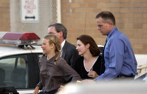 Elizabeth Smart, accompanied by her mother Lois and two unidentified men gets rushed into an unmarked van from the Salt Lake City Police department and taken to her home.  Elizabeth Smart who was abducted last June was found alive and well in Sandy early Wednesday afternoon.  Photo by Francisco Kjolseth/The Salt Lake Tribune.