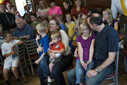 Chris Detrick  |  The Salt Lake Tribune
Elayna Saley, 8, sits on her dad Chad's lap as she is announced the winner at McDonald's, 2310 E. 2100 S., in Salt Lake City Wednesday June 6, 2012.  As one of only two winners nationwide, Saley will get to travel to London this summer to attend the 2012 Summer Olympics in London. Sitting to the left are her mom, Victoria, and brothers James, 6, and Clark, 2.