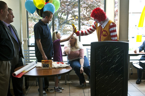 Chris Detrick  |  The Salt Lake Tribune
Elayna Saley, 8, gets a high five from Ronald McDonald at McDonald's, 2310 E. 2100 S., in Salt Lake City Wednesday June 6, 2012.  As one of only two winners nationwide, Saley will get to travel to London this summer to attend the 2012 Summer Olympics in London.