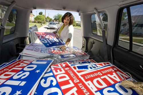 Paul Fraughton  |  Salt Lake Tribune
Josie Valdez, a Democratic candidate for the Utah Senate, pulls lawn signs from the back of her car while canvasing in a Midvale neighborhood.