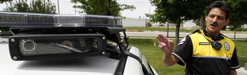 Al Hartmann  |  The Salt Lake Tribune 
Ogden Police master officer Tim Shelstead points to one of the four rooftop cameras that are placed beneath the light bar on a specially equipped Ogden police car that can read license plates in real time. Agencies around the state are using license plate scanners to aid highway and street patrol cars in apprehending criminals.   They can determine if the car's registration and insurance is up to date.