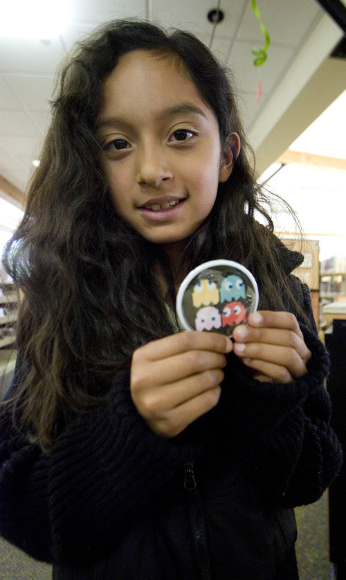 Paul Fraughton / Salt Lake Tribune
Angela Huerta, age 9, shows off the button she made at the library.The activity is one  the West Valley Library will feature in its summer reading program.

 Friday, May 25, 2012