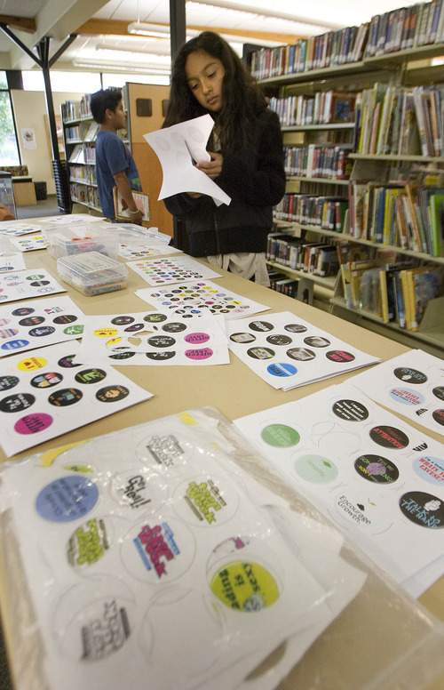 Paul Fraughton / Salt Lake Tribune
Angela Huerta, age 9, cuts out a design to make into a button. The activity is one  the West Valley Library will feature in its summer reading program.

 Friday, May 25, 2012