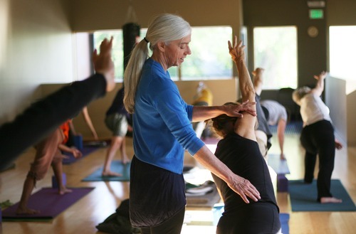 Kim Raff | The Salt Lake Tribune
Charlotte Bell helps Sandy MacLeod with a pose while leading a yoga class at the IWKI studio in Salt Lake City on May 30, 2012. Bell recently published a book called 