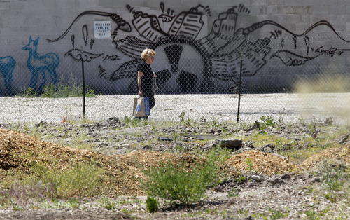Al Hartmann  |  The Salt Lake Tribune 
A pedestrian walks past the empty lot that has been locally named the 