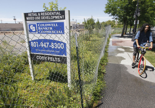 Al Hartmann  |  The Salt Lake Tribune 
When it is completed, the planned Sugar House Crossing development is expected to change the face of the community -- a stark contrast from the empty lot that has proved an eyesore for the past three years. A bicyclist rides along Highland Drive near the so-called 