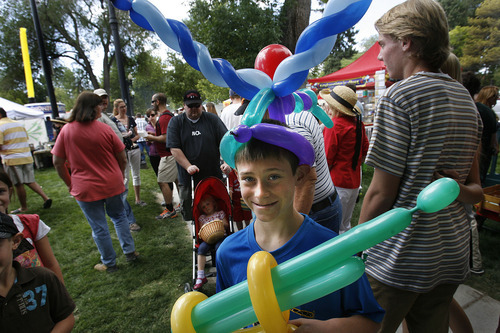 Scott Sommerdorf  |  The Salt Lake Tribune             
Dallin Koerner of Montana enjoys his balloon hat and gun while touring the opening Saturday of the Salt Lake Farmer's Market, Saturday, June 9, 2012.