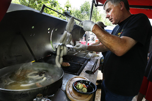 Scott Sommerdorf  |  The Salt Lake Tribune             
Sausages being cut prior to being boiled at the Siegfried's booth at the opening Saturday of the Salt Lake Farmer's Market, Saturday, June 9, 2012.