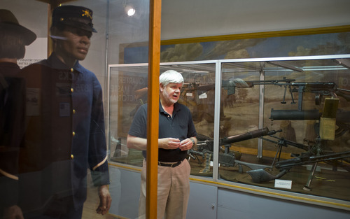 Trent Nelson  |  The Salt Lake Tribune
Fort Douglas Museum Director Robert Voyles with displays on buffalo soldiers, left, and weaponry, Tuesday, June 5, 2012 in Salt Lake City, Utah. The 150th anniversary celebration of Fort Douglas will take place June 16th with a variety of military-themed exhibits including tanks and helicopters.