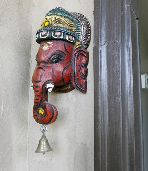Al Hartmann  |  The Salt Lake Tribune 
Ganesha lord of success and destroyer of obstacles greets visitors at the front door of the Swathy and Maha Mahasenan home.