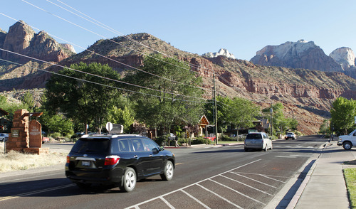 Al Hartmann  |  The Salt Lake Tribune 
Cars drive on Zion Park Blvd. in Springdale to enter Zion National Park Monday June 11.   A Utah state audit says that Springdale police were illegally collecting money from foreign tourists and some of the cash is missing.