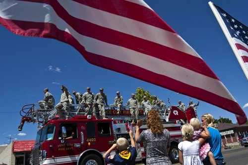 Chris Detrick  |  The Salt Lake Tribune
Members of the Utah Army National Guard 624th Engineer Company wave to a crowd of supporters during a parade along 100 North in Price Tuesday June 12, 2012. Around sixty soldiers from Utah will be deployed for a year to Afghanistan.