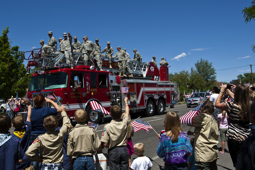 Chris Detrick  |  The Salt Lake Tribune
Members of the Utah Army National Guard 624th Engineer Company wave to a crowd of supporters during a parade along 100 North in Price Tuesday June 12, 2012. Around sixty soldiers from Utah will be deployed for a year to Afghanistan.