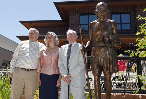 Al Hartmann  |  The Salt Lake Tribune 
Sculptor Dennis Smith, left, Anne Burkholder, YWCA's chief executive officer, and Boyer Jarvis, board member of the Ghandi Alliance for Peace, pose for unveiling of the new sculpture of Mahatma Gandhi in front of the the YWCA's new Center for Families.