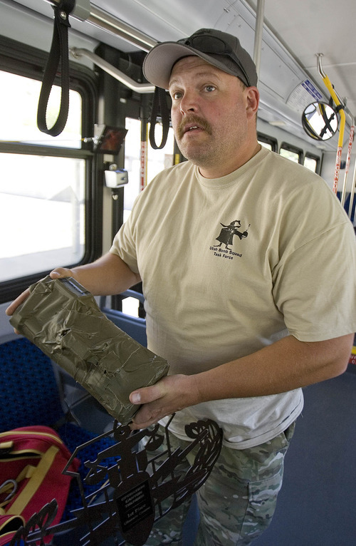 Paul Fraughton | The Salt Lake Tribune
Sgt. Troy Beebe of Provo Police Department holds a mock bomb as he explains a problem set up for bomb squads. This was one of eight scenarios faced by members of area bomb squads at a training exercise/competition held at  the Utah County Sheriff's Firearms Range near Thistle on Wednesday, June 13, 2012.