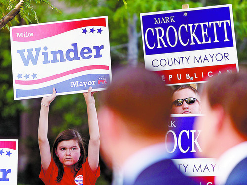 Trent Nelson  |  The Salt Lake Tribune
Mike Winder supporter Jessica Winder (Winder's daughter), left, and Mark Crockett supporter Skylar Burnside hold signs as the two Republican candidates for Salt Lake County mayor face off at a debate on Main Street Wednesday, June 13, 2012 in Salt Lake City, Utah.