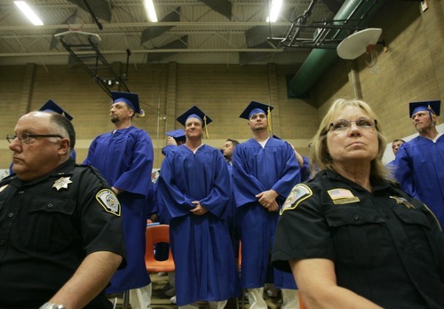 Kim Raff | The Salt Lake Tribune
Prison guards watch over inmates in the gym at the Timpanogos Women's Facility at the Utah State Prison during a commencement exercise on June 13, 2012.  The Utah State Prison and Canyons School District presented diplomas to about 340 men and women who have graduated from the prison's high school or G.E.D. programs.