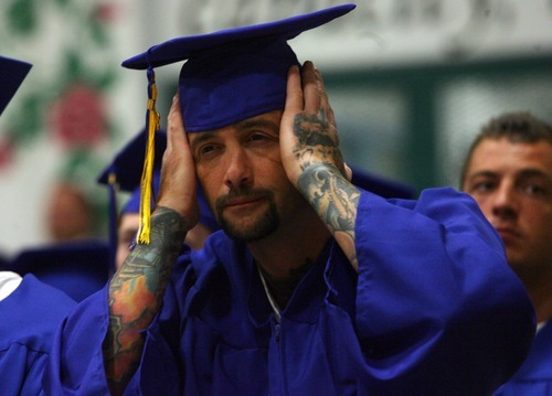 Kim Raff | The Salt Lake Tribune
Jason Champagne fixes his mortar board before receiving his diploma during a commencement exercise at the Utah State Prison in Draper, Utah, on June 13, 2012. The Utah State Prison and Canyons School District presented diplomas to about 340 men and women who have graduated from the prison's high school or G.E.D. programs.