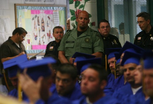 Kim Raff | The Salt Lake Tribune
A prison guard watches over inmates in the gym at the Timpanogos Women's Facility at the Utah State Prison in Draper, Utah, June 13, 2012, during a commencement exercise for inmates who received their high school or G.E.D. diplomas. The Utah State Prison and Canyons School District presented diplomas to about 340 men and women. Most completed adult high school programs.