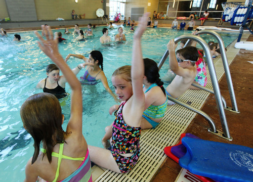 Lennie Mahler  |  The Salt Lake Tribune
Children learn swimming basics as they participate in the World's Largest Swimming Lesson on Thursday, June 14, 2012, at the South Davis Recreation Center. More than 500 locations around the world participated in the event.