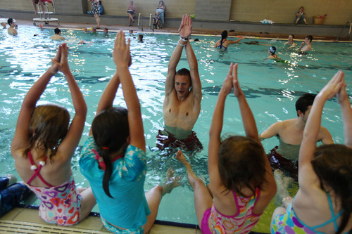 Lennie Mahler  |  The Salt Lake Tribune
Spencer Scheese instructs children on swimming basics during the World's Largest Swimming Lesson on Thursday, June 14, 2012, at the South Davis Recreation Center. More than 500 locations around the world participated in the event.